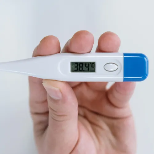 Digital thermometer showing high fever as a warning sign of illness